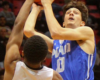 William D. Lewis The Vindicator Poland's Daniel Kramer(10) shoots past Buchtel's Jonathan King(2)).