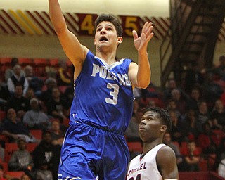 William D. Lewis The Vindicator Poland's Braeden O'Shaughnessy(3) shoots past Buchtel's Chris Livingston (24).