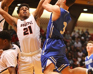 William D. Lewis The Vindicator Poland's Braeden O'Shaughnessy (3)) shoots past Buchtel's Chris Livingston (24).