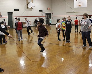Neighbors | Abby Slanker.With the help of C.H. Campbell Elementary School physical education teacher Ronie Haurin (right),.a fourth-grade student took her turn at the double long jump rope station during the school’s annual American Heart Association’s Kids Heart Challenge on Feb. 6..