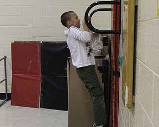 Neighbors | Abby Slanker.A Hilltop Elementary School first-grade student showed his strength as he tried out the pull up bar during the school’s annual American Heart Association Kids Heart Challenge on Feb. 6.