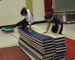 Neighbors | Abby Slanker.Two Hilltop Elementary School first-graders took their turn jumping over the ‘mat mountain’ during the school’s annual American Heart Association Kids Heart Challenge on Feb. 6.