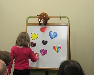 Neighbors | Jessica Harker.Children placed pieces of matching hearts together on a magnetic board on Feb. 14 at the Boardman library's Night Owls event.