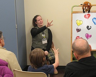 Neighbors | Jessica Harker.Youth librarian Rhonda Monroe taught children gathered at the Boardman library on Feb. 14 the American Sign Language sign for love at the Night Owls Valentine's Day event.
