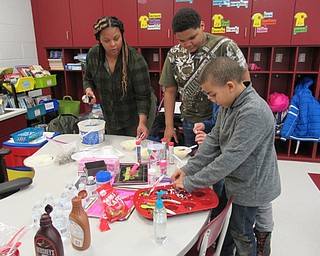 Neighbors | Jessica Harker.Third-grade students buried their ice cream in chocolate and caramel sauce, as well as different kinds of sprinkles and candy provided by the PTO, on Feb. 14 to celebrate Valentine's Day.