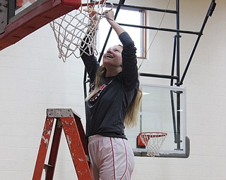 Neighbors | Abby Slanker.Canfield Village Middle School eighth-grade girls basketball player Bella Kennedy took her turn cutting down the net to celebrate the team’s 2019 AAC championship at the school’s gym on Feb. 18. .