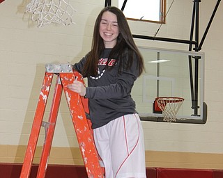 Neighbors | Abby Slanker.Canfield Village Middle School eighth-grade girls basketball player Mackenzie Koenig cut a piece of the basketball net as a keepsake of the team’s 2019 AAC championship at the school’s gym on Feb. 18.