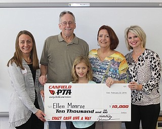Neighbors | Abby Slanker.Canfield PTA president Julie Miller (left) and first vice president overseeing fund raising for the Canfield PTA Noelle Domer (right) presented Canfield PTA’s Crazy Cash Giveaway winner Ellen Monroe, her husband Russ and her daughter Mena with a check for $10,000 on March 5.