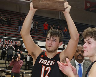 Springfield senior Shane Eynon (12) holds up the Regional Runner-up trophy to the fans after Friday night's game against Richmond at the Canton Fieldhouse.  Dustin Livesay   |   The Vindicator  3/15/19  Canton.