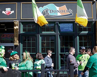 People stand outside of O'Donold's at Shamrock the Block on Sunday afternoon. EMILY MATTHEWS | THE VINDICATOR