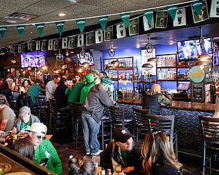People gather for food and drinks inside the Federal during Shamrock the Block on Sunday afternoon. EMILY MATTHEWS | THE VINDICATOR