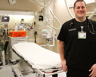 Dr. Chad Donley, regional medical director for Mercy Health emergency departments, stands by a bed inside St. Elizabeth Youngstown Hospital's emergency room. Through a $250,000 state grant, the emergency room soon will begin dispensing buprenorphine as treatment for people struggling with opioid addiction.
