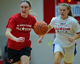 CANFIELD, OHIO - MARCH 19, 2019: Howland's Alex Ochman dribbles ahead of Southern's Riley Felton during the first half of the 49th annual Al Beach Classic, Tuesday night at Canfield High School. DAVID DERMER | THE VINDICATOR