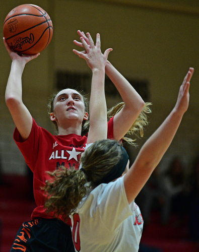 CANFIELD, OHIO - MARCH 19, 2019: Howland's Alex Ochman goes to the basket against Jackson Milton's Ashley Cameron during the first half of the 49th annual Al Beach Classic, Tuesday night at Canfield High School. DAVID DERMER | THE VINDICATOR