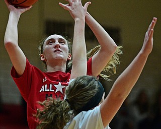 CANFIELD, OHIO - MARCH 19, 2019: Howland's Alex Ochman goes to the basket against Jackson Milton's Ashley Cameron during the first half of the 49th annual Al Beach Classic, Tuesday night at Canfield High School. DAVID DERMER | THE VINDICATOR