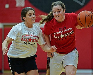 CANFIELD, OHIO - MARCH 19, 2019: Champion's Abby White is pressured by South Range's Bri Modic during the first half of the 49th annual Al Beach Classic, Tuesday night at Canfield High School. DAVID DERMER | THE VINDICATOR