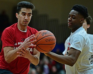 CANFIELD, OHIO - MARCH 19, 2019: Girard's Austin Claussell has the ball knocked from his control by Boardman's Che Trevena during the first half of the 49th annual Al Beach Classic, Tuesday night at Canfield High School. DAVID DERMER | THE VINDICATOR