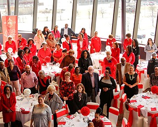 Attendees of the Delta Sigma Theta Sorority, Inc. Youngstown Alumnae Chapter Founders Day Celebration stand for the Black National Anthem on Saturday afternoon in YSU's DeBartolo Stadium Club. EMILY MATTHEWS | THE VINDICATOR