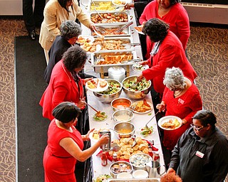 Attendees of the Delta Sigma Theta Sorority, Inc. Youngstown Alumnae Chapter Founders Day Celebration receive lunch on Saturday afternoon in YSU's DeBartolo Stadium Club. EMILY MATTHEWS | THE VINDICATOR