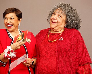 Beverly E. Smith, left, the National President and CEO of Delta Sigma Theta Sorority, Inc., receives photos as a gift from Youngstown Alumnae Chapter member Nikki Davis during the Delta Sigma Theta Sorority, Inc. Youngstown Alumnae Chapter Founders Day Celebration on Saturday afternoon in YSU's DeBartolo Stadium Club. EMILY MATTHEWS | THE VINDICATOR