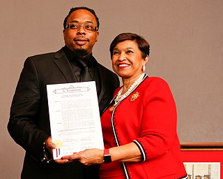 Youngstown City Councilman Julius Oliver presents Beverly E. Smith, the National President and CEO of Delta Sigma Theta Sorority, Inc., with a resolution during the Delta Sigma Theta Sorority, Inc. Youngstown Alumnae Chapter Founders Day Celebration on Saturday afternoon in YSU's DeBartolo Stadium Club. EMILY MATTHEWS | THE VINDICATOR