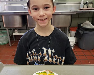 Neighbors | Submitted.Tyler Gulosh posed with his pizza art creation at the Tot Chefs after school program at Boardman. The program is designed to help children learn how to make healthy snacks.