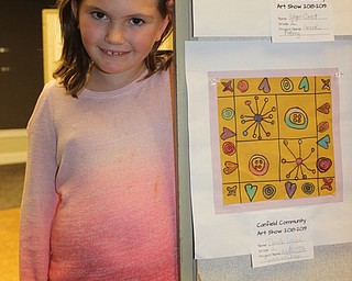 Neighbors | Abby Slanker.C.H. Campbell Elementary School second grade student Danielle Laslow attended the opening night reception of the Canfield Schools art show, where her Adinkra African Cloth Symbols and Design art work was displayed, at the Canfield library on Feb. 21.