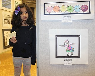 Neighbors | Abby Slanker.C.H. Campbell Elementary School kindergartner Senuli Thantirige checked out her self portrait which was highlighted at the opening night reception of the Canfield Schools art show at the Canfield library on Feb. 21.