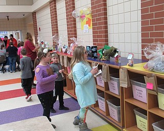 Neighbors | Jessica Harker .Children added tickets to their baskets of choice for the Chinese auction at the annual Austintown Intermediate School Bingo fundraiser night on March 1.