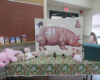 Neighbors | Jessica Harker .Books about pigs and pig decorations were scattered around the Metro Park Farm March 2 for the Pig Day celebration.