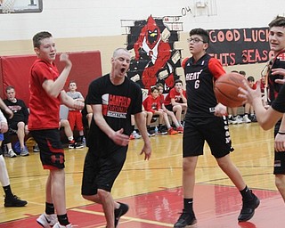 Neighbors | Abby Slanker.Canfield Village Middle School Assistant Principal Michael Flood battled against members of the eighth-grade boys basketball team during the school’s fourth annual Students Versus Staff Basketball Game on March 7.