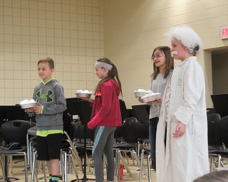 Neighbors | Jessica Harker .Third-grade students at Austintown Intermediate School, Dominic Boano, Krystyn Shrock, Addison Mitulinski and Emily Davis, prepared to throw pies at their principals on March 14 in celebration of Pi Day.