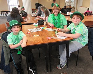 Neighbors | Jessica Harker.Jack, Ginger and Izzy Zink all worked on decorating bracelets at the Poland library March 16 for the annual St. Patrick's Day celebration.