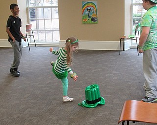 Neighbors | Jessica Harker.Children tried to toss plastic balls into a leprechauns hat March 16 at the Poland library's annual St. Patrick's Day party.