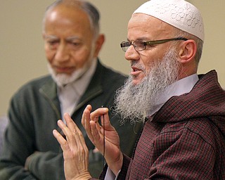William D. Lewis The Vindicator Azeddine Jaidi of Yunus emre Mosque of Youngstown speaks while Dr. Klaid Iqbal, president of the Islamic Society of Greater Youngstown listens during a vigil 3-22-19 remembering 50 people killed at a New Zealand mosque.