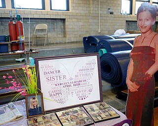 Photos of Kyrsten Studer, who was killed by a drunken driver in 2003 when she was 16, are displayed at the annual Kyrsten's Kloset, where anyone can get a free prom or formal dress and accessories as long as they sign a promise not to drink and drive on Saturday at the former Roosevelt Elementary in Hubbard. EMILY MATTHEWS | THE VINDICATOR