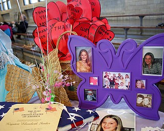 Photos of Kyrsten Studer, who was killed by a drunken driver in 2003 when she was 16, are displayed at the annual Kyrsten's Kloset, where anyone can get a free prom or formal dress and accessories as long as they sign a promise not to drink and drive on Saturday at the former Roosevelt Elementary in Hubbard. EMILY MATTHEWS | THE VINDICATOR