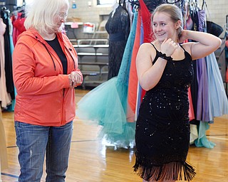 Sadie Mink, 17, shows her grandmother Doris Sicignano, of Mercer, Pa., a dress she tried on at the annual Kyrsten's Kloset, where anyone can get a free prom or formal dress and accessories as long as they sign a promise not to drink and drive on Saturday at the former Roosevelt Elementary in Hubbard. EMILY MATTHEWS | THE VINDICATOR