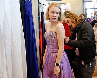 Andrea Ryan, the wife of congressman Tim Ryan, helps Shianna Gibbons, 16, of Liberty, with the back of her dress at the annual Kyrsten's Kloset, where anyone can get a free prom or formal dress and accessories as long as they sign a promise not to drink and drive on Saturday at the former Roosevelt Elementary in Hubbard. EMILY MATTHEWS | THE VINDICATOR