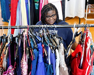Nakia Thomas, 15, of Austintown, looks at dresses at the annual Kyrsten's Kloset, where anyone can get a free prom or formal dress and accessories as long as they sign a promise not to drink and drive on Saturday at the former Roosevelt Elementary in Hubbard. EMILY MATTHEWS | THE VINDICATOR