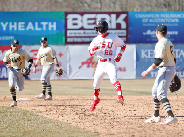 YSU's Cameron Murray gets caught in a rundown as Oakland's Mike Mcgee (2) runs at him with the ball during the first game of their double header on Saturday at Eastwood Field. EMILY MATTHEWS | THE VINDICATOR