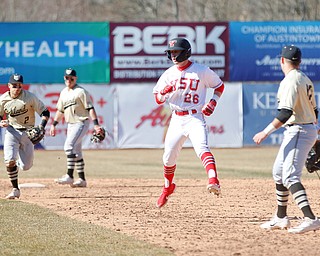 YSU's Cameron Murray gets caught in a rundown as Oakland's Mike Mcgee (2) runs at him with the ball during the first game of their double header on Saturday at Eastwood Field. EMILY MATTHEWS | THE VINDICATOR