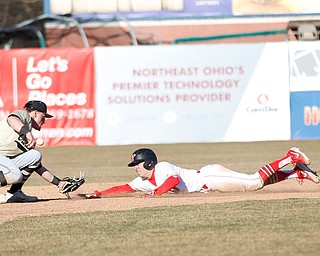 YSU's Lucas Nasonti slides safely into second as Oakland's second baseman Mario Camilletti misses the ball during the second game of their double header on Saturday at Eastwood Field. EMILY MATTHEWS | THE VINDICATOR