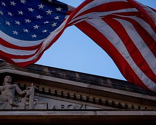 An American flag flies outside the Department of Justice in Washington, Friday, March 22, 2019. Special counsel Robert Mueller has concluded his investigation into Russian election interference and possible coordination with associates of President Donald Trump. The Justice Department says Mueller delivered his final report to Attorney Barr, who is reviewing it. (AP Photo/Andrew Harnik)
