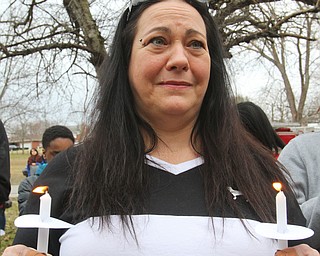 William D. Lewis The Vindicator  Tina Mumfor, sister in law of a man killed in a Campbell car crash holds acandles during a 3-24-129 vigil at Roosevelt Park.