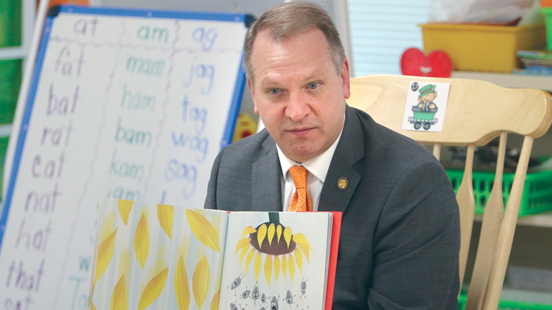 State Rep. Don Manning of New Middletown, R-59th, reads a children’s book to Austintown Elementary School kindergartners in Tammy Deeley’s classroom Monday morning. Manning met earlier that day with school officials on access to mental and behavioral health services. 