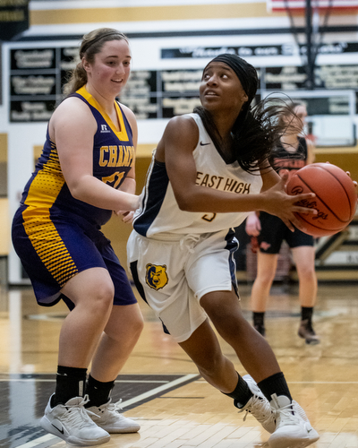 DIANNA OATRIDGE | THE VINDICATOR  Youngtown East's Deja Monroe (right) looks to drive to the hoop as Champion's Abby White (left) defends during the Frank Bubba All-Star Classic in Warren on Tuesday.