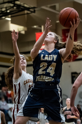 DIANNA OATRIDGE | THE VINDICATOR  Brookfield's Bailey Drapola (24) drives to the hoop as Cardinal Mooney's Carolyn Kay defends during the Frank Bubba All-Star Classic in Warren on Tuesday.
