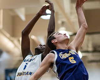 DIANNA OATRIDGE | THE VINDICATOR  Valley Christian's Milan Square (left) and Champion's Joe Abramovich (right) reach for a rebound during the Frank Bubba All-Star Classic in Warren on Tuesday.