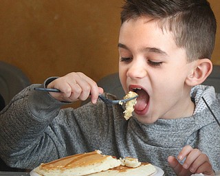 William D. Lewis The Vindicator  Maxwell Guido, 8, of Boardman chows down on pancakes at 3-24-19 pancake event in Boardman Park.